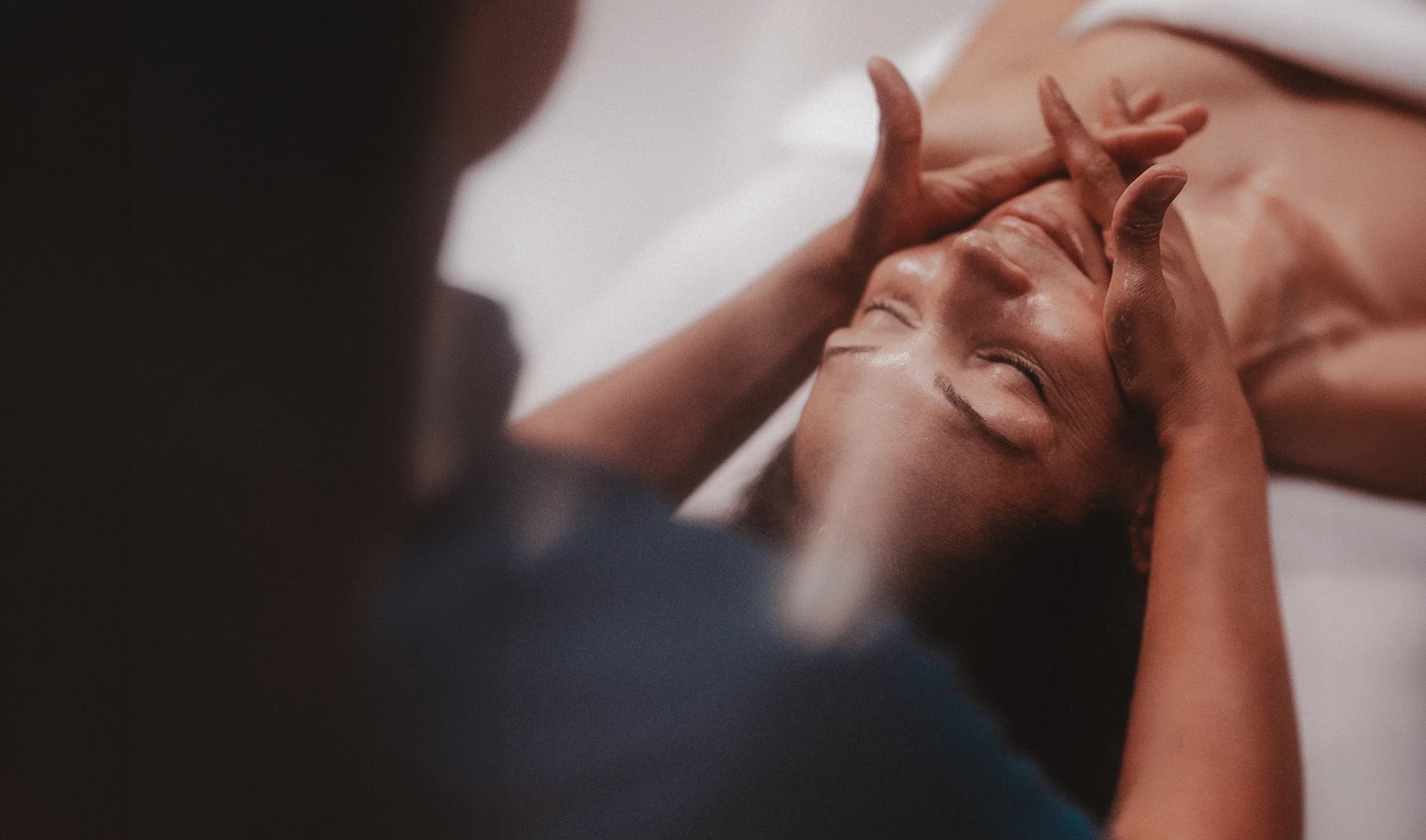 Smiling woman laying down getting a facial